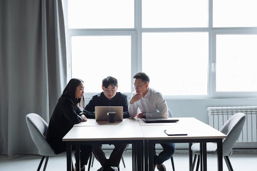 A group of creative professionals collaborating in a bright workspace