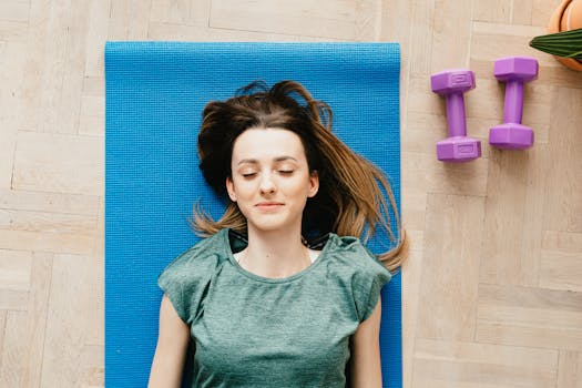 relaxed person lying on a yoga mat