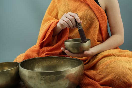 person relaxing with sound healing instruments